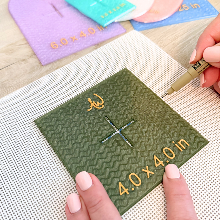 Square needlepoint template positioned on blank canvas for accurate tracing and centering