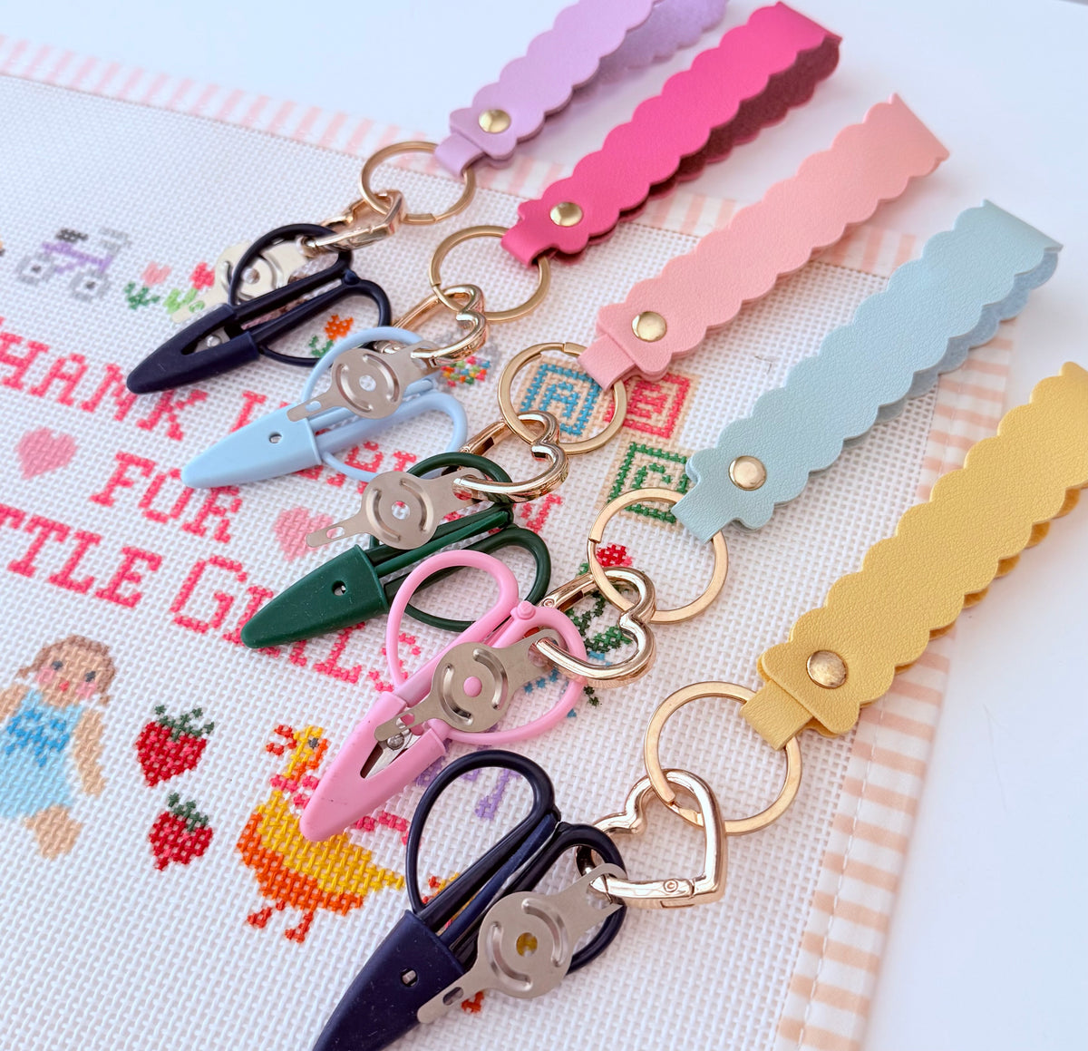 The Stitching Sidekick Needlepoint Snips & Threader Set.  All in one scissors and needle threader on a beautiful scallop keychain.