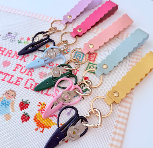 The Stitching Sidekick Needlepoint Snips & Threader Set.  All in one scissors and needle threader on a beautiful scallop keychain.