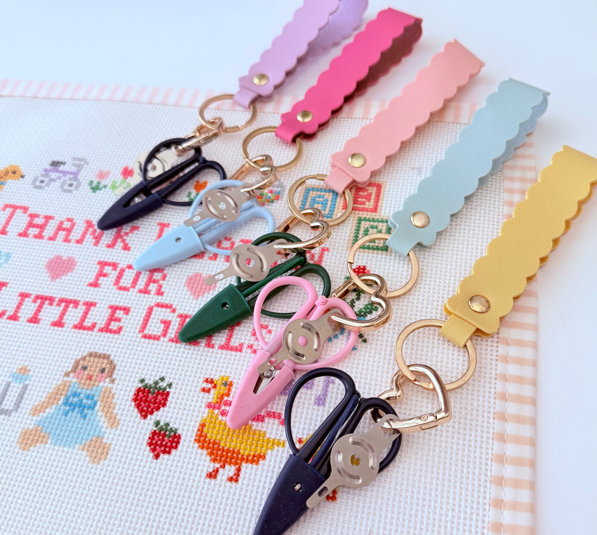 Needlepoint scissors and needlethreader together on a beautiful scallop keychain. These are the popular snips everyone needs for needlepointing.