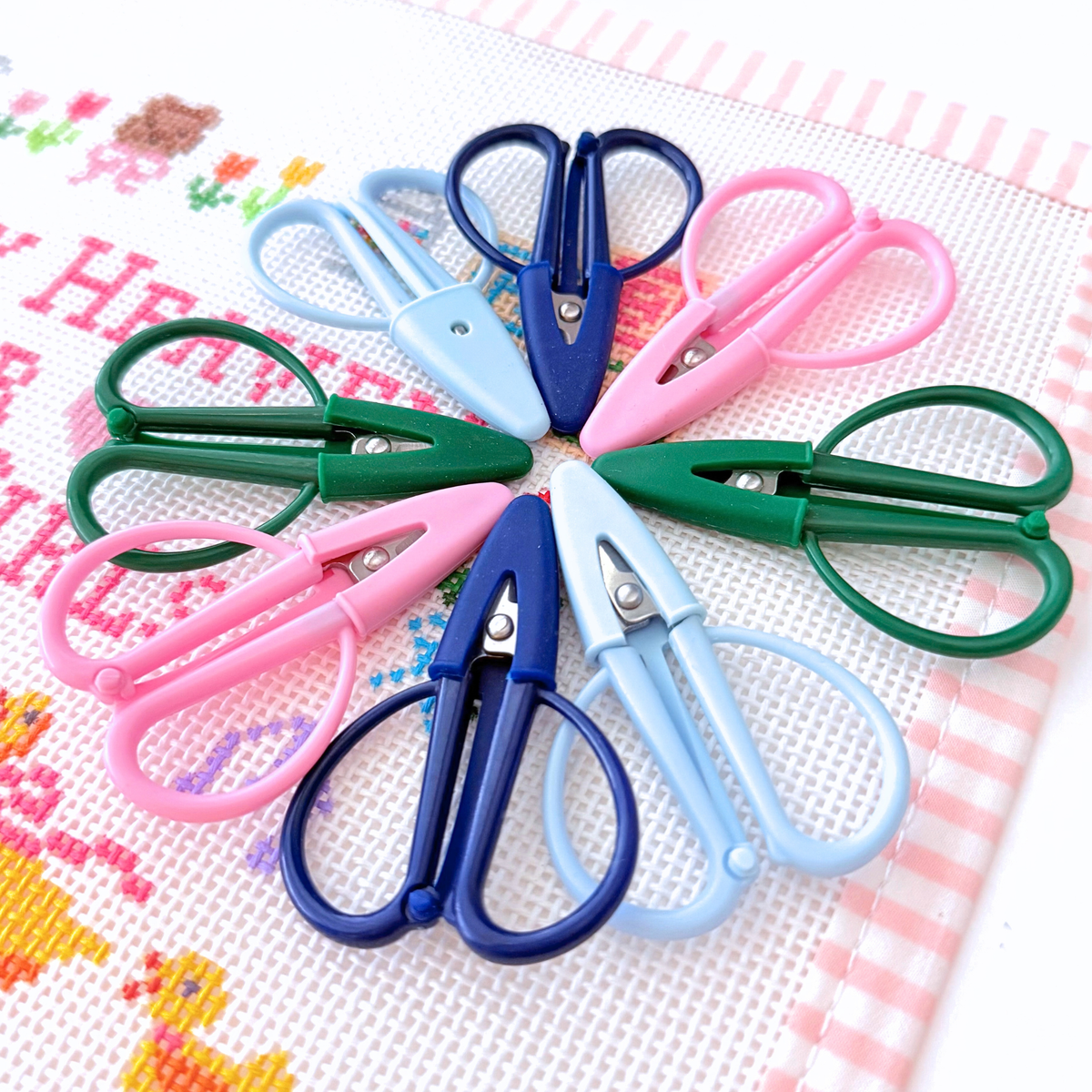 Mini needlepoint snips with pointed thread scissors and attached protective cover