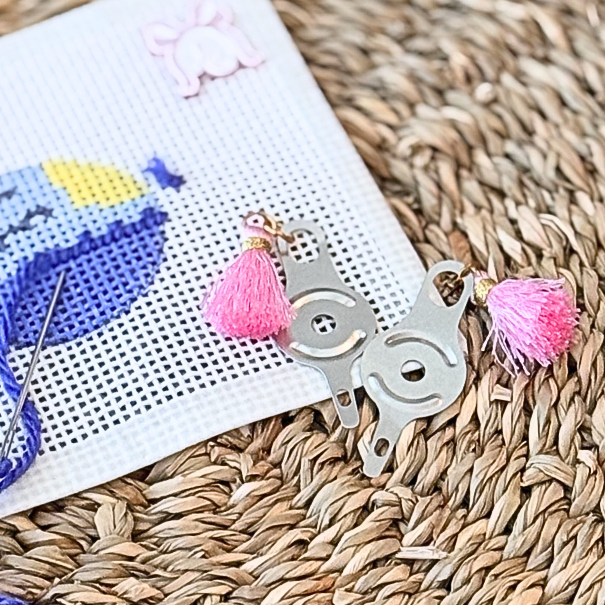 Needle threader with pink tassel for needlepoint project bags