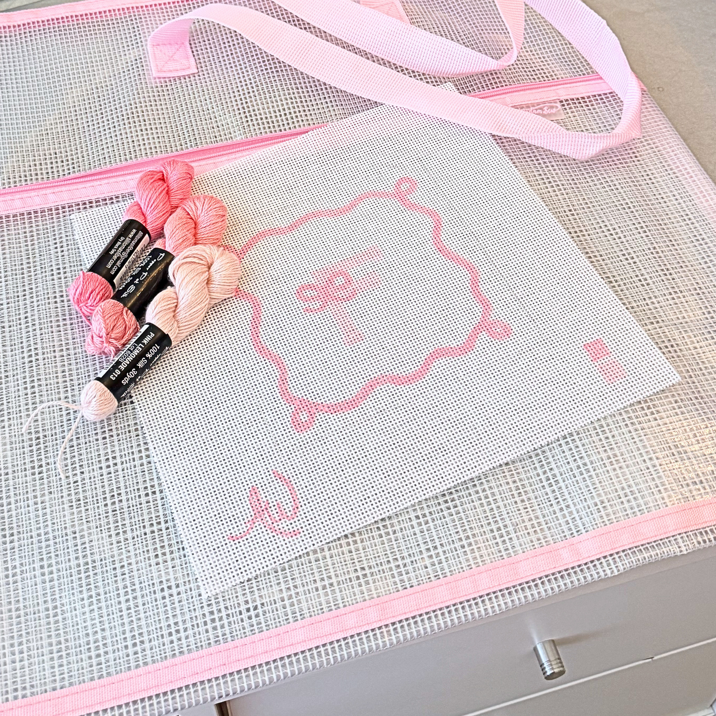 Pink needlepoint project bag for organizing WIPs accessories and tools