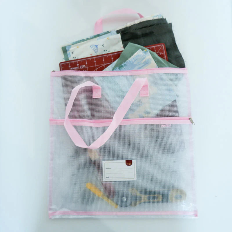Pink needlepoint project bag for organizing WIPs accessories and tools