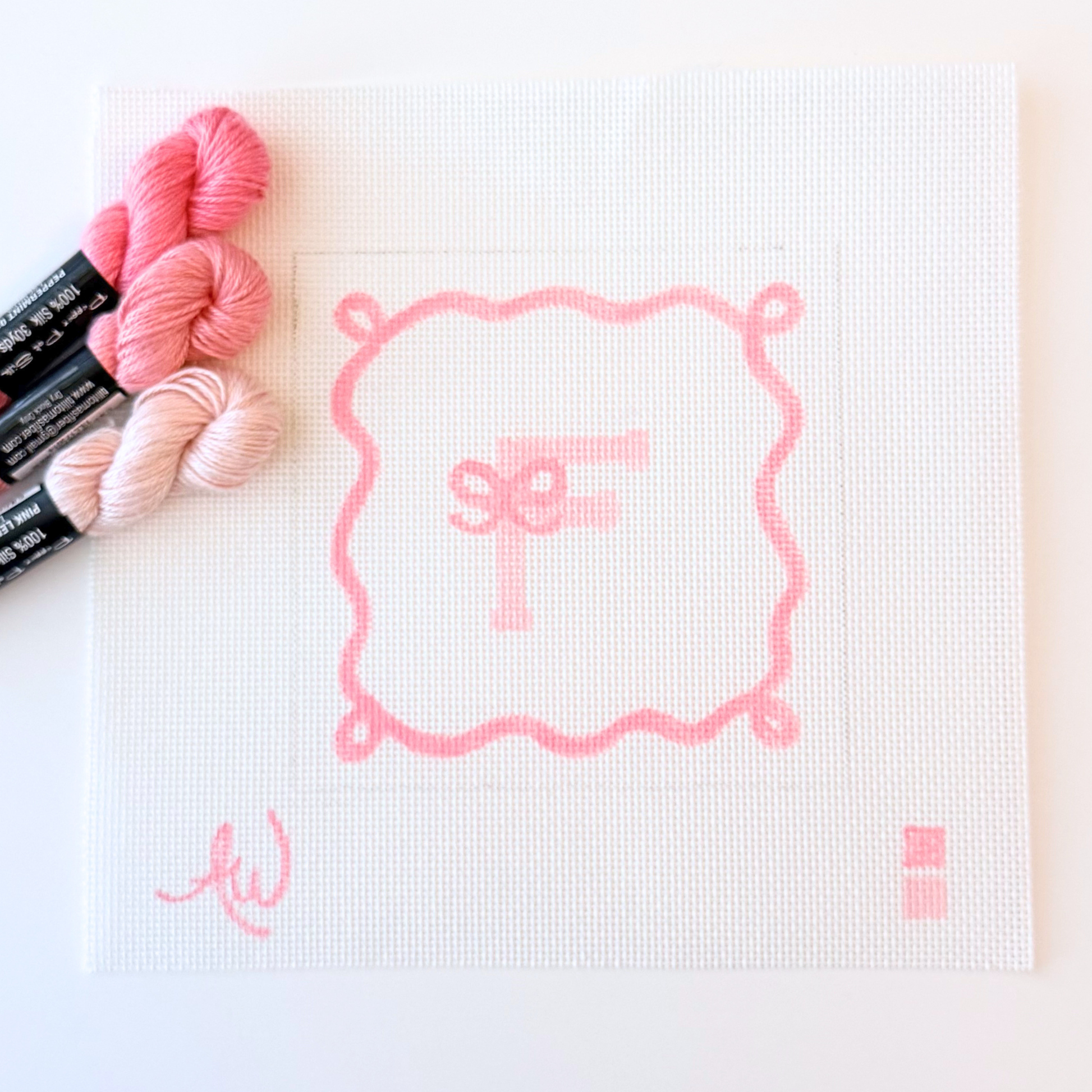 Personalized initial needlepoint canvas with ribbon-style frame on 16 count