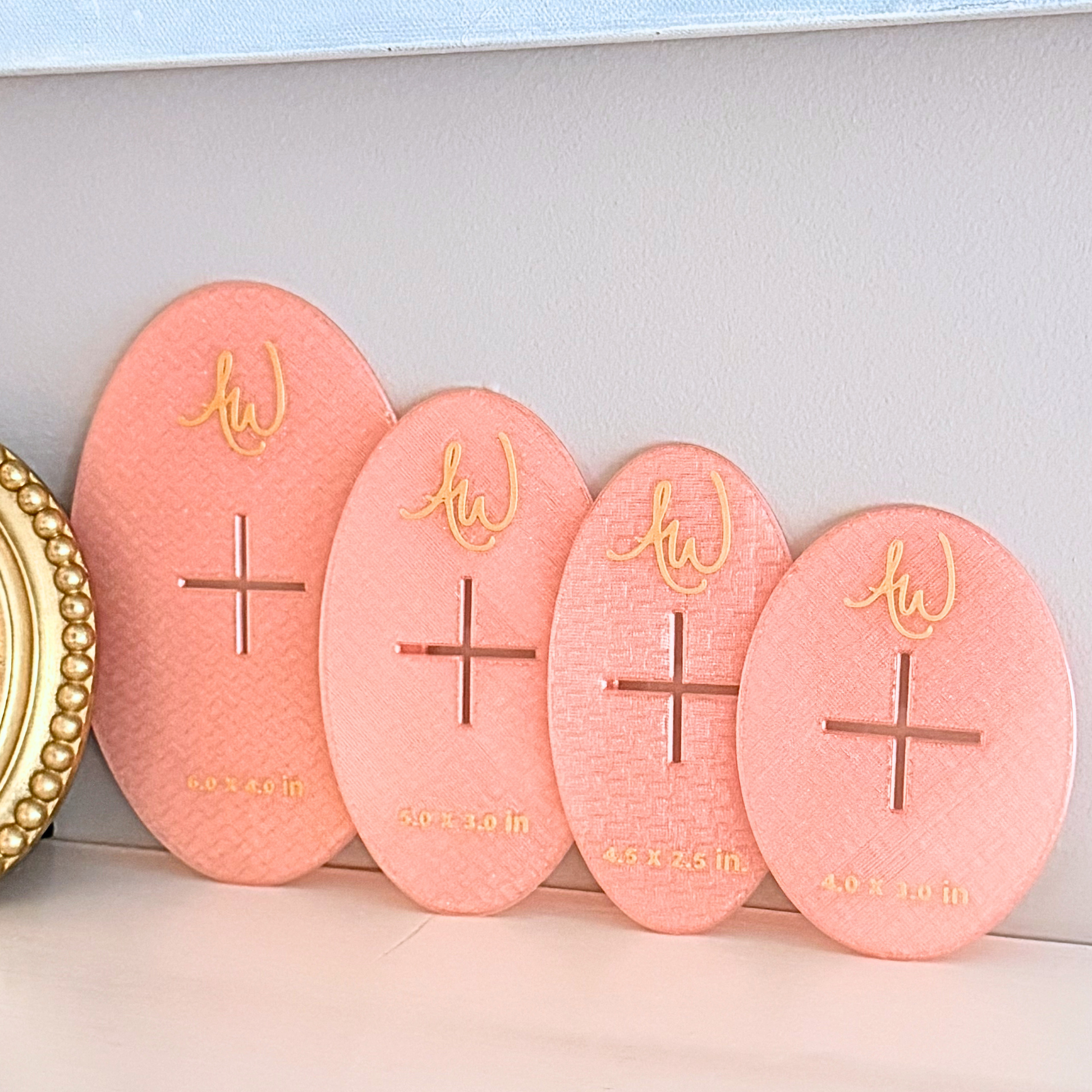 Oval needlepoint stencil set pictured on a mantle.