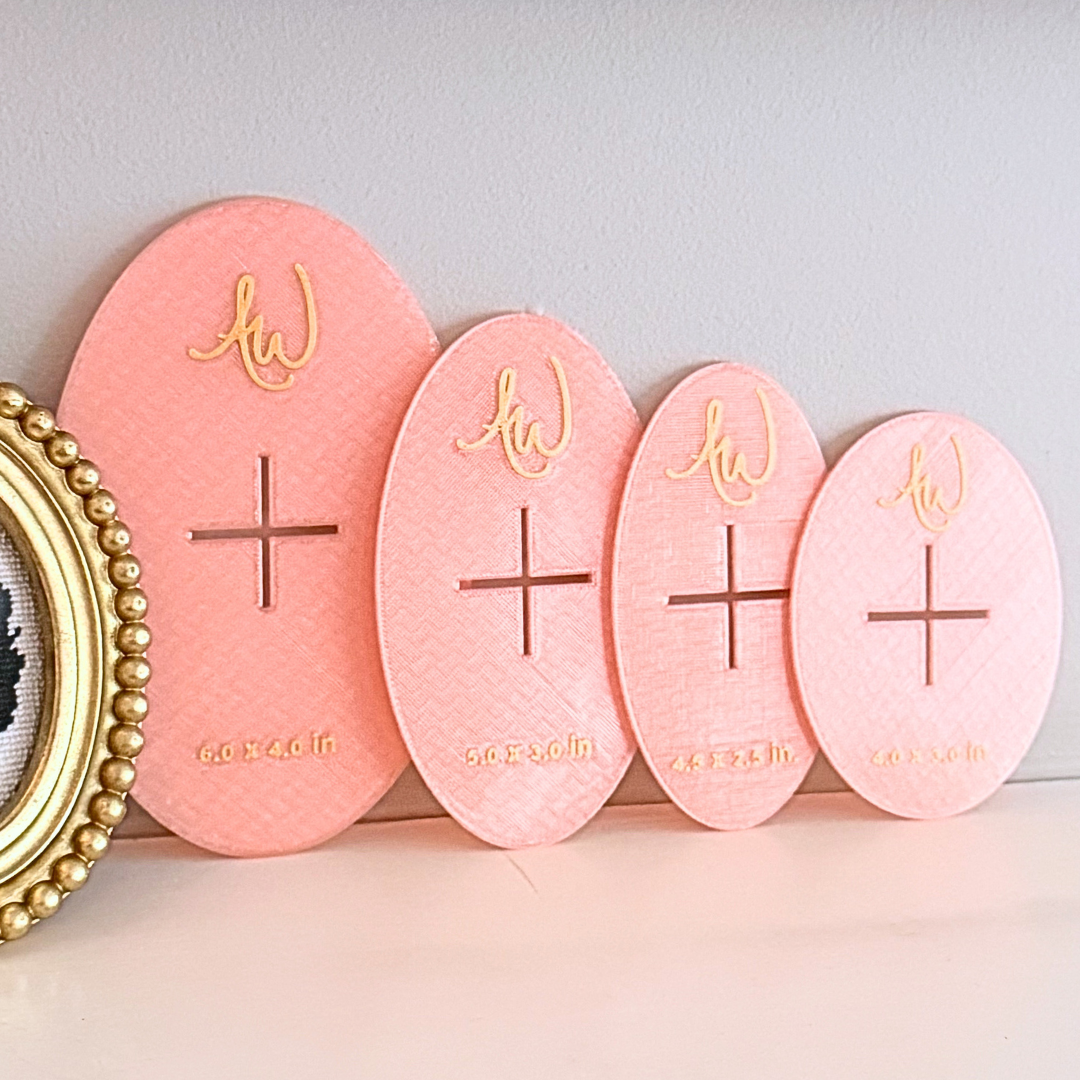 Oval needlepoint stencil set pictured on a mantle.