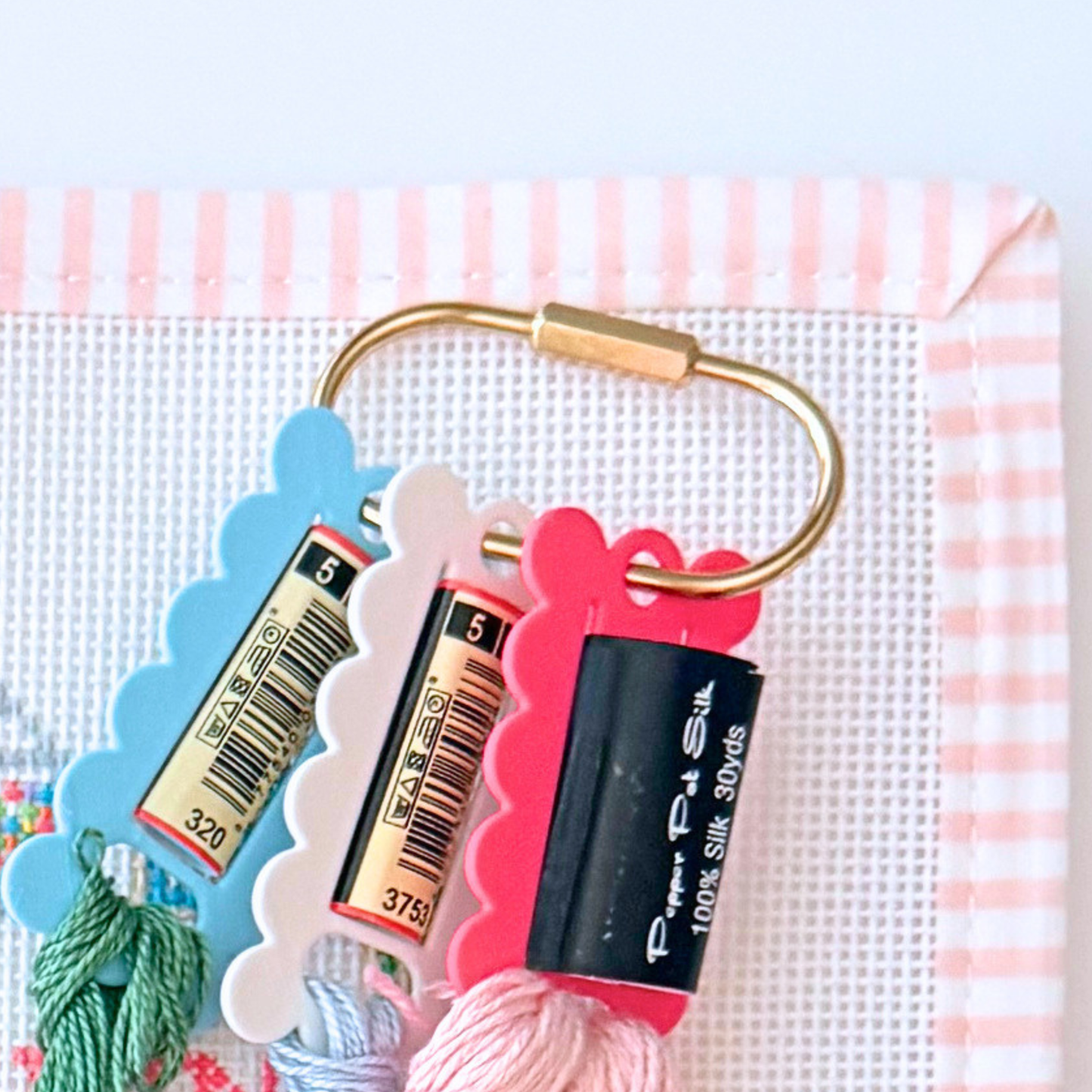 Gold project bag accessory for organizing needlepoint project threads.