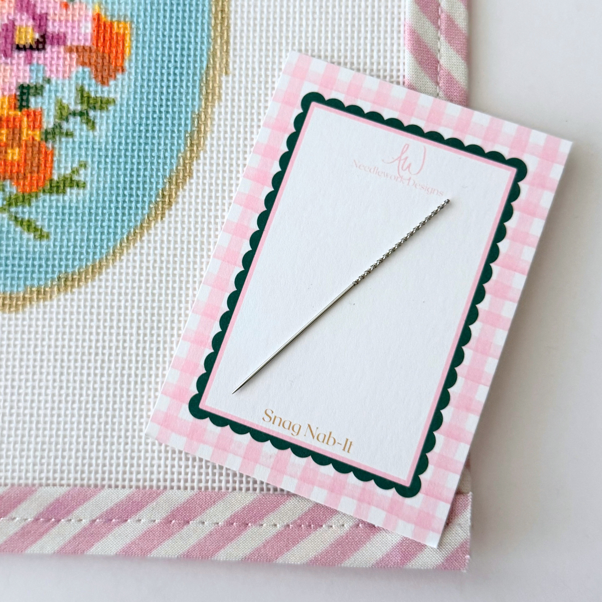 Loose thread on needlepoint canvas use a Dritz Snag Nab-It repair tool